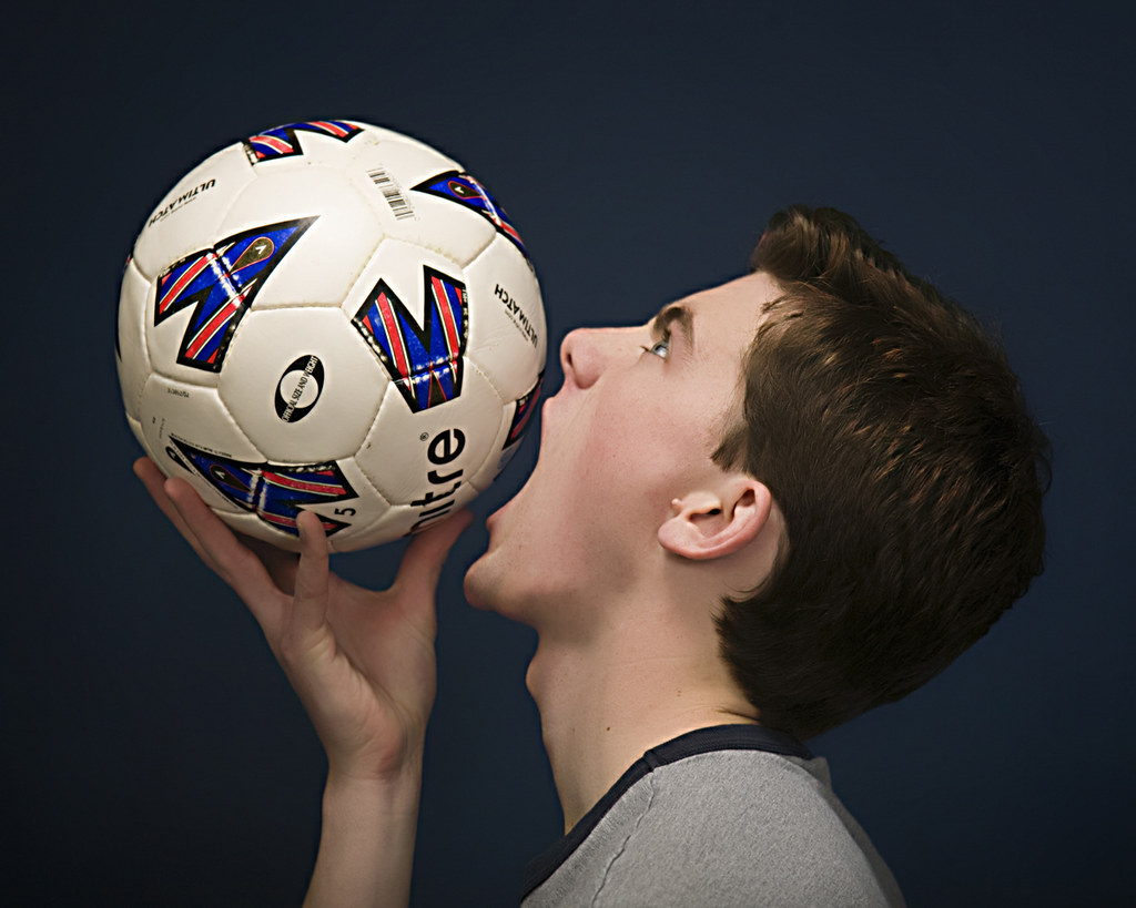 a boy eating a soccer ball