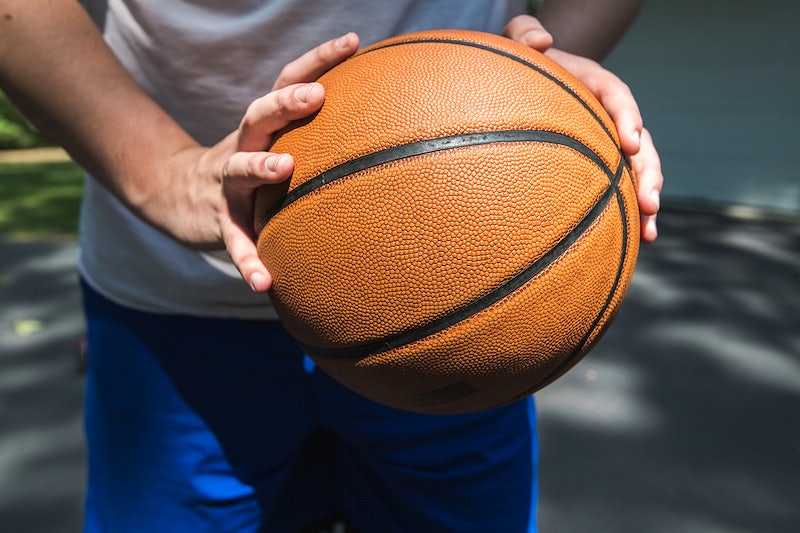 holding basketball